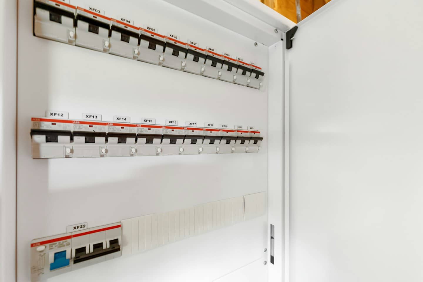 An open electrical breaker panel with labeled circuit switches.